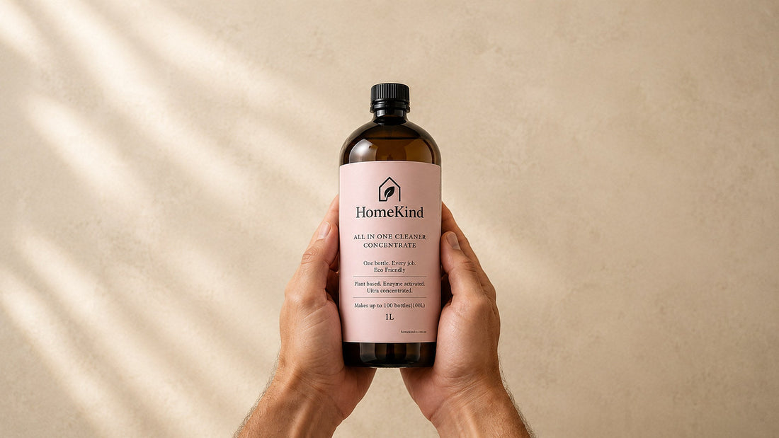 Hands holding a bottle of HomeKind concentrate