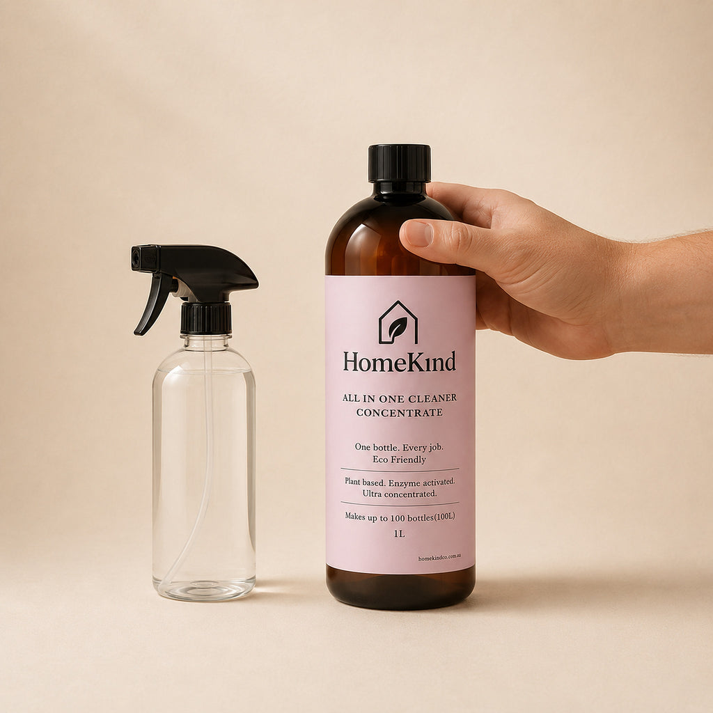 HomeKind 1L bottle shown next to a standard spray bottle and a hand for scale
